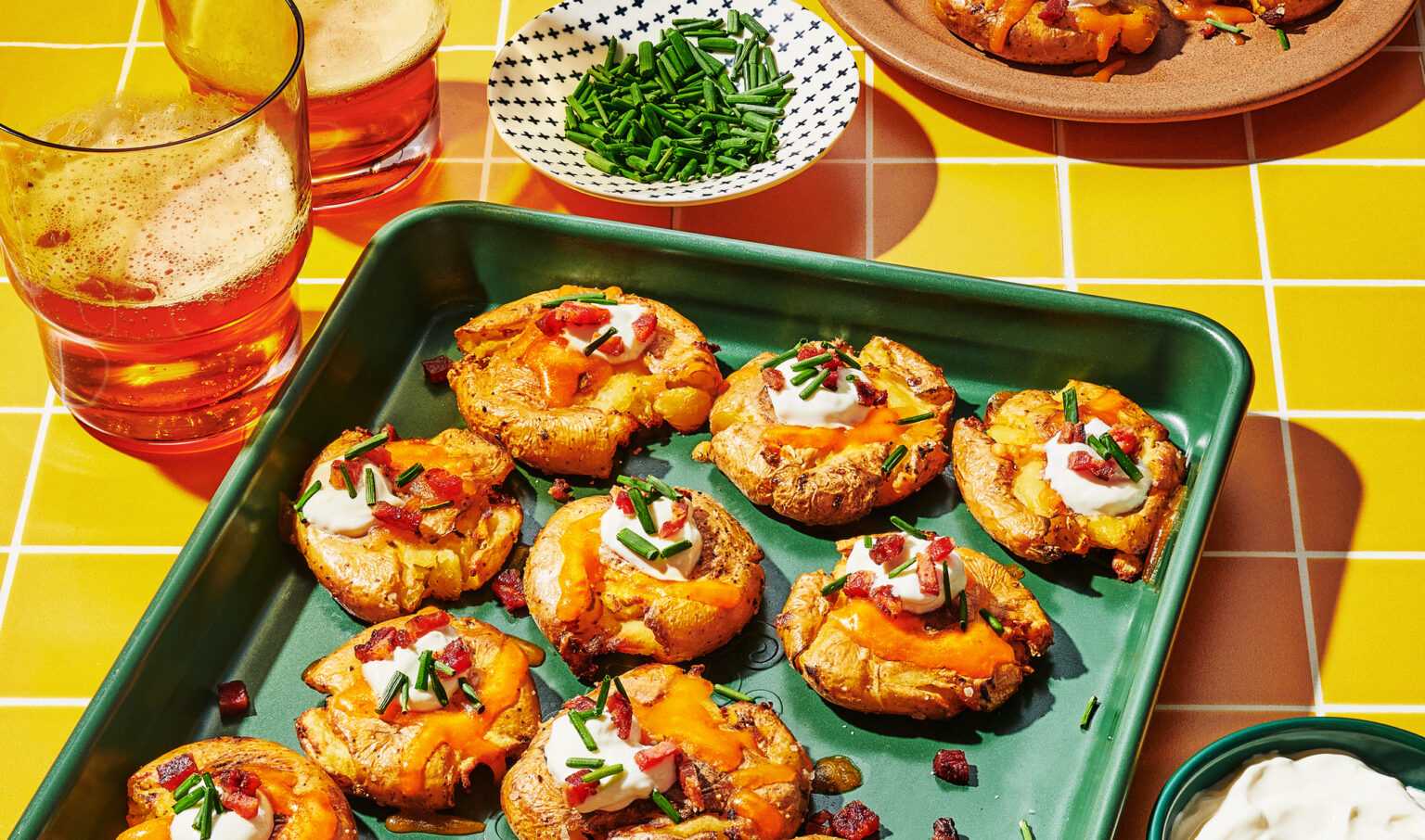 Smashed baby potatoes on baking sheet.
