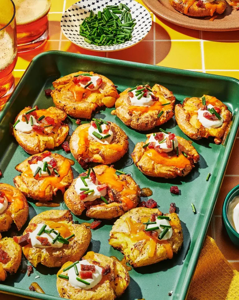 Smashed and loaded yellow baby potatoes with cheddar, sour cream, bacon and chives